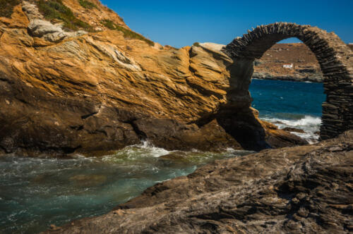 Ancient bridge to small island near the town of Andros, Andros,